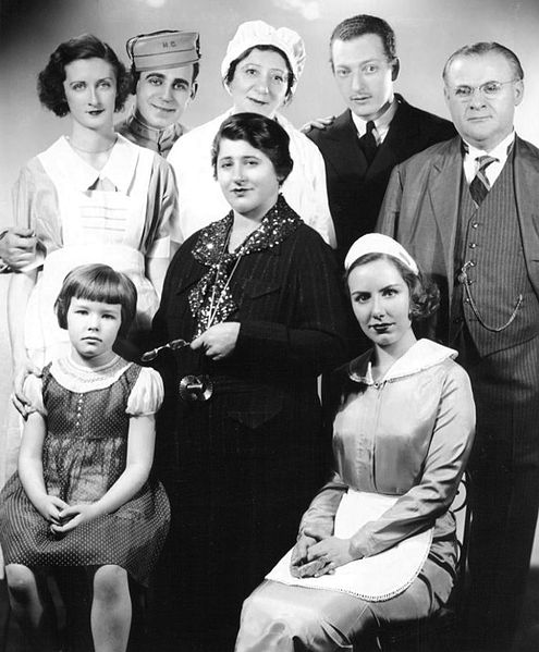 The cast of Gertrude Berg's radio series House of Glass (1935); Sloane is located second from right in the back row.