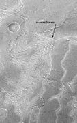 Inverted Streams near Juventae Chasma, Syrtis Major quadrangle, as seen by Mars Global Surveyor. These streams begin at the top of a ridge then run together.