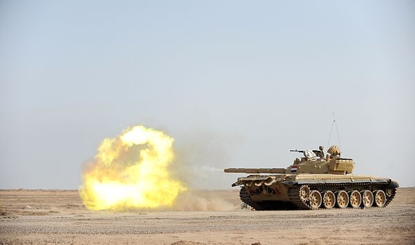 An Iraqi T-72 tank fires.