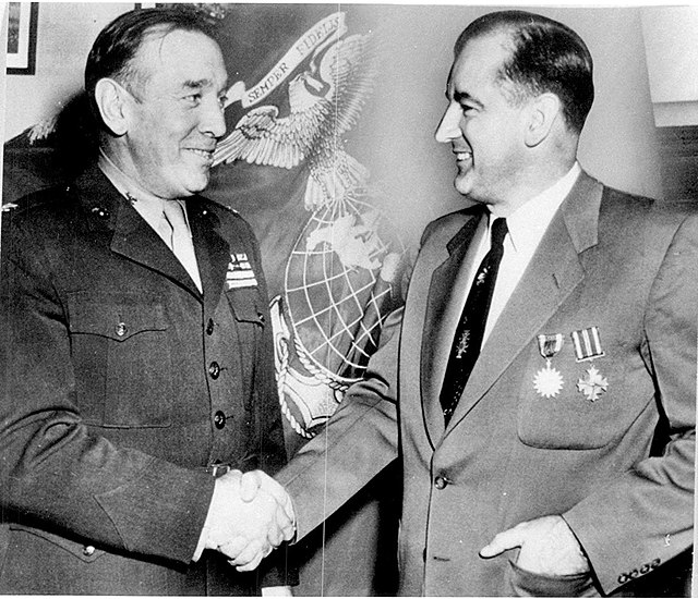 McCarthy receiving his DFC and Air Medal from Colonel John R. Lanigan, commanding officer of Fifth Marine Reserve District, December 1952