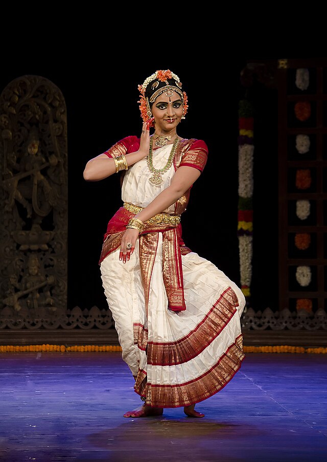 Kuchipudi dancer in Aralam mudra depicting a mother holding her child -  SuperStock