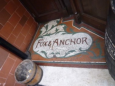 Mosaic in floor of entrance, Fox & Anchor Pub, 115 Charterhouse Street, London (8475013835).jpg