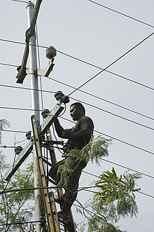 A man working on powerlines in Nauru (2007) NAURU JULY 2007 (10709113444).jpg
