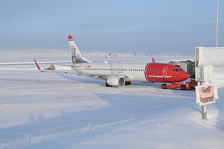 A Norwegian Air Shuttle 737-8JP aircraft at a snowy Rovaniemi Airport