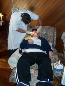 Paralysed and functionally dependant patient receiving dental care Paralysed and functionally dependant patient receiving dental care.png