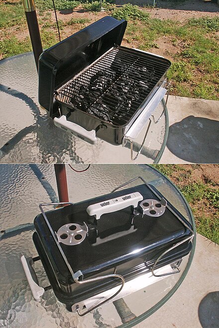 Portable charcoal grills are small but convenient for traveling, picnicking, and camping. This one is loaded with lump charcoal. The legs fold up and lock onto the lid so it can be carried by the lid handle.