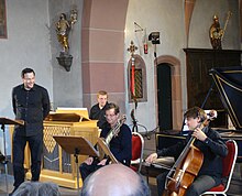 Andreas Scholl and members of the Baroque orchestra Accademia Bizantina in a concert of the Rheingau Musik Festival (RMF) at the church of Hallgarten, 16 July 2011 RMF Andreas Scholl Accademia Bizantina.jpg