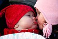 Baby and child kiss