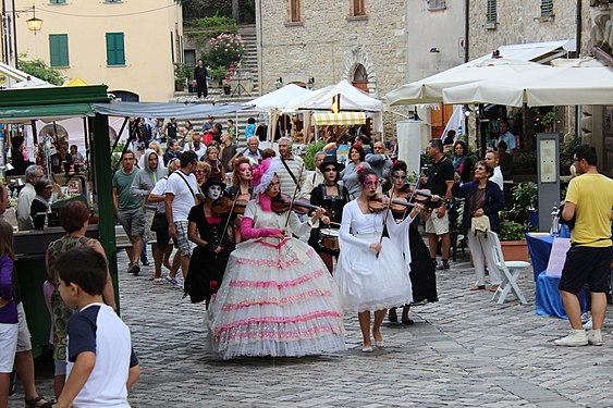 Street orchestra playing music during the AlchimiAlchimie event in San Leo, Italy