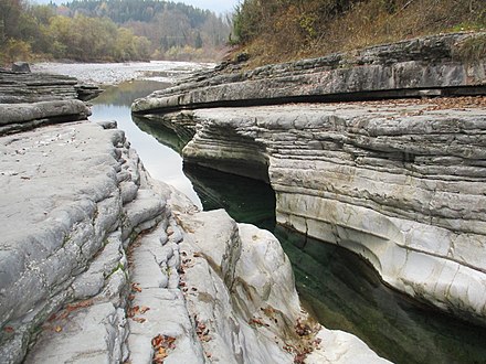 Layers of chalk exposed by a river eroding through them