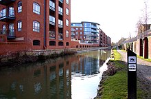 The Oxford Canal from Walton Well Road in 2010. The modern apartments by the canal to the left have replaced the former Lucy's Ironworks. The Oxford Canal by Walton Well Road - geograph.org.uk - 1760226.jpg