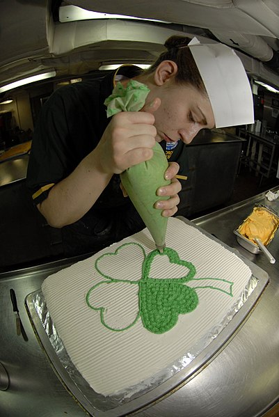 File:US Navy 090317-N-2475A-043 Culinary Specialist 3rd Class Rechele Rosposa, from Bremerton, Wash., decorates a Saint Patrick's Day cake in the ship's bake shop aboard the aircraft carrier USS John C. Stennis (CVN 74).jpg