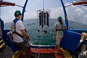 Researchers watch while a CTD-rosette is lowered into the water from EPA's Bold research vessel.
