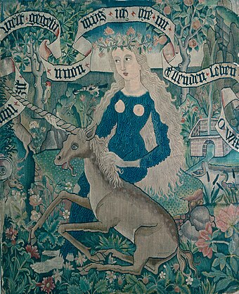 Wild woman with unicorn, tapestry c. 1500–1510 (Basel Historical Museum). As with most Renaissance wild women, she is hairy over the areas a dress would cover, except for the breasts.