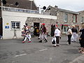 River Road, at the section close to the Wightlink ferry terminal, Yarmouth, Isle of Wight during the Old Gaffers Festival on 6th June 2010. A marching band can be seen playing.