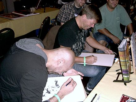 Liefeld and Marat Mychaels share a laugh as they sketch at the Big Apple Convention in Manhattan, October 2, 2010