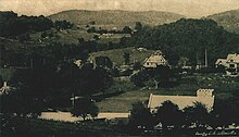 A valley with clearings, houses, and a church