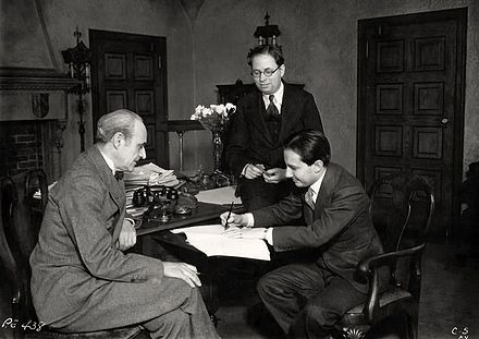 From left, Joseph P. Bickerton, Jr. (theatre producer), Elmer Rice (playwright) and Carl Laemmle Jr. (Universal producer) sign a contract for the film version of Counsellor at Law