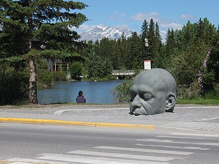 The Big Head sculpture in Canmore, located on main street north side of the bridge over Policeman's Creek