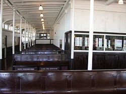 View of the seating area on Eureka's upper deck. The magazine shop is visible to the right behind the glass. The restaurant was on this level at the far end of the deck Eurekacabin.jpg