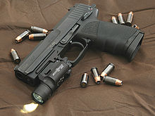 USP45 with SureFire light attachment HK USP 45 surrounded by .45 caliber Hornady TAP (+P) jacketed hollow point rounds.jpg