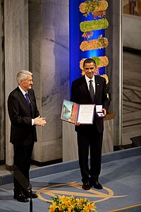 Nobel Committee chairman Thorbjorn Jagland presents to U.S. President Barack Obama with the 2009 Nobel Peace Prize medal and diploma during the Nobel Peace Prize ceremony in Radhuset Main Hall at Oslo City Hall, in December 2009. Horbjorn Jagland presents President Barack Obama with the Nobel Prize medal and diploma.jpg