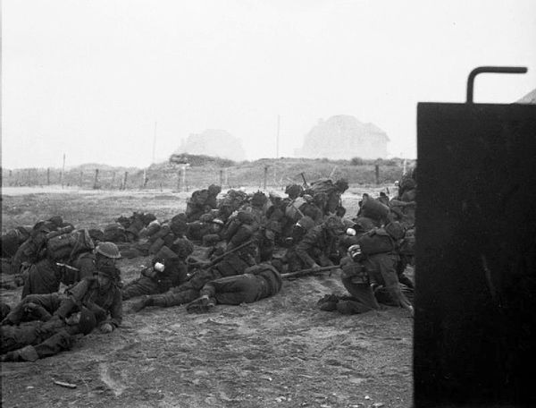 British infantry waiting to move off Queen Beach, SWORD Area, while under heavy enemy fire, on the morning of 6 June