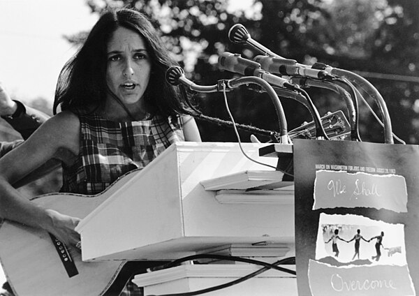 Baez playing at the March on Washington in August 1963