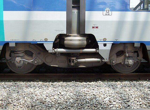 Jacobs bogie of a KTX-I train. The two trailers rest on the large air spring of the secondary suspension (partially covered by the mud flaps), below i