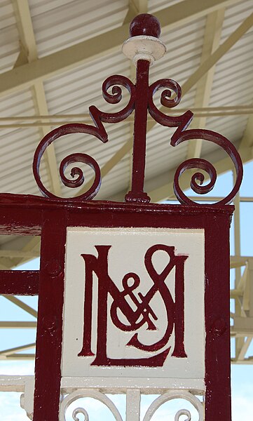 File:London Midland & Scottish emblem cast in to the gates of Llandudno railway station.jpg