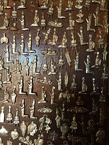 Milagros nailed to the church bell at San Miguel Mission of Santa Fe, New Mexico. Milagros San Miguel Mission.jpg