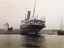 Isle of Man Steam Packet Company vessel RMS Mona aground on the Conister Rock. Note the whitewashed seaward side of the tower, supposed to make it more visible to shipping. Mona aground on the Conister Rock..JPG