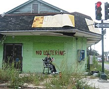 Work on building in the Lower Ninth Ward of New Orleans, August 2008 No Loitering Banksy.jpg