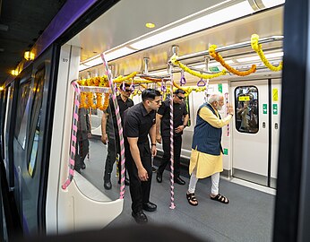 PM intracting with the metro staff & school students as he travels with them in India's first underwater metro train during the inauguration (2).jpg