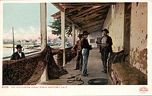 Fishermen at the Old Custom House, circa 1900. Postcard of the Old Custom House Porch.jpg