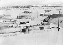 Snowed-up technical huts and airfield at Reykjavik, Iceland, during a lull in the blizzard which hit the island between 21 and 27 February 1945. Consolidated Liberator GR Mark VIs of No.53 Squadron RAF are parked on the airfield Royal Air Force Coastal Command, 1939-1945. CS354.jpg