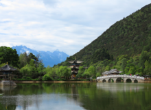 Qing dynasty buildings around the Black Dragon Pool with the Jade Dragon Snow Mountain in the background.