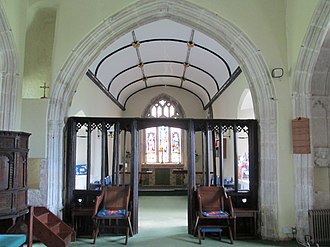 The chancel arch and rood screen, looking towards the chancel St Peter's Church Portesham 1.jpg