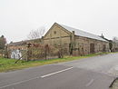 Barn and enclosure wall of a four-sided courtyard