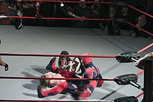 Suicide performing a leg drop on Chris Sabin. Suicide Leg Drop.jpg