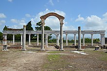 The macellum The macellum (market) dating to the Hadrianic period (117-138) and the reconstructed monumental colonnade, Minturnae, Minturno, Italy (14814631847).jpg