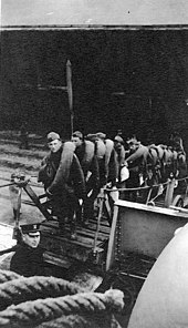 Troops board Kroonland at Saint-Nazaire, France, on 11 March 1919 to return to the United States. Troops loading on USS Kroonland, 11 March 1919.jpg