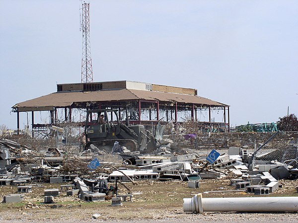 US Navy 050902-N-0000X-017 A U.S. Navy Seabee uses a traxcavator to remove debris from Hurricane Katrina on board Naval Construction Battalion Center 