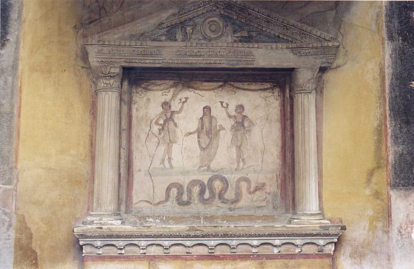 Lararium depicting tutelary deities of the house: the ancestral Genius (center) flanked by two Lares, with a guardian serpent below