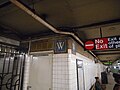 On the Botanical Garden-bound platform, there are two "W" mosaics on a corner.