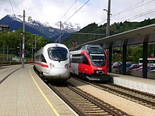 departing InterCityExpress next to a regional train in Landeck-Zams OBB 4011 und 4024 in Landeck.jpg