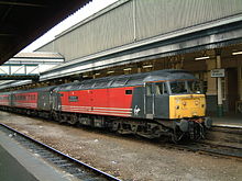 47817 in Virgin Trains livery at Exeter St Davids station. 47817 The Institution of Mechanical Engineers at Exeter St Davids.jpg