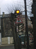 A traffic signal ahead sign in France. (the light flashes to indicate a red light ahead)