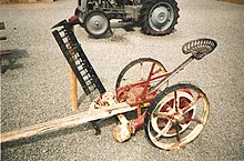 Horse-drawn mower with a "sulky seat" Animal-drawn grass mower.jpg