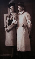 Two jewish people in Nazi Germany wearing armbands emblazoned with the six-pointed Star of David